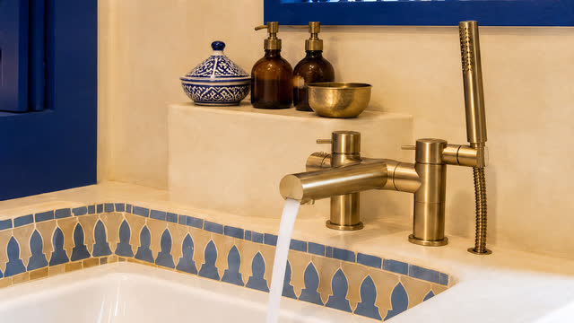 A brass faucet running above the frieze.
