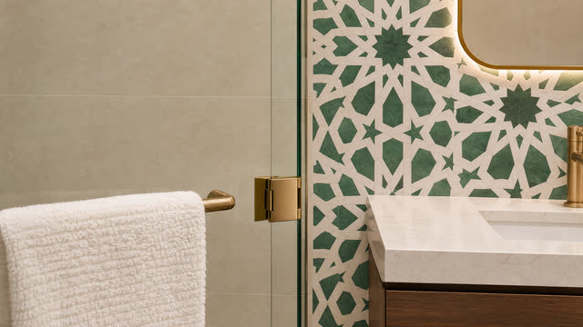The zellige pattern carries through the room to the glass shower.