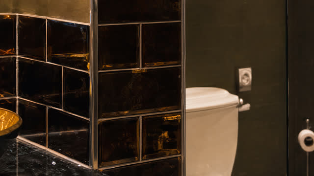 Glossy black tiles edged with gold trims.