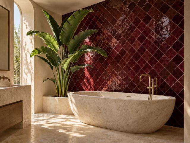 Bathroom with a burgundy diamond zellige wall and a stone tub