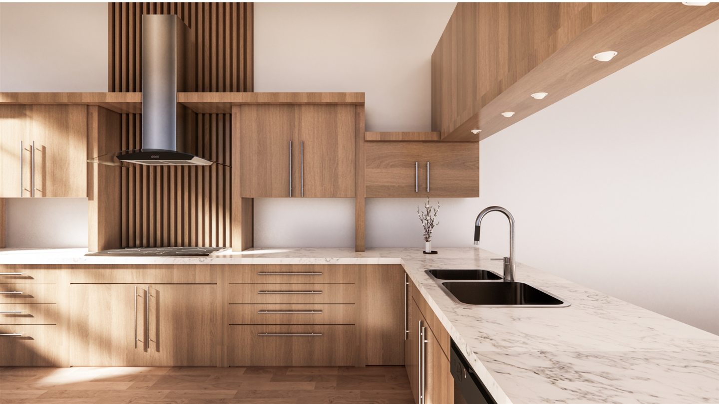 Cuisine en bois clair avec plans de travail en marbre, hotte inox et évier double baigné de lumière