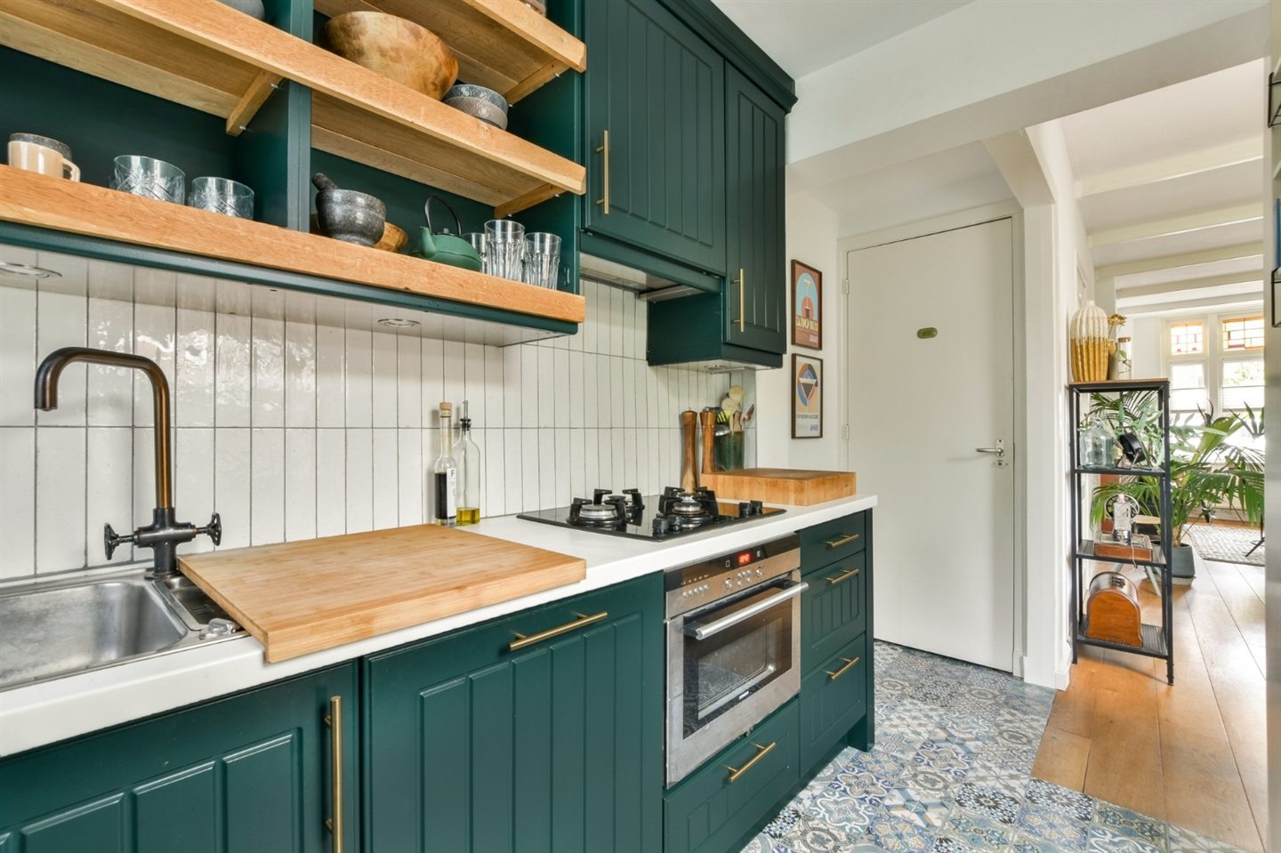 Green kitchen with a wooden countertop