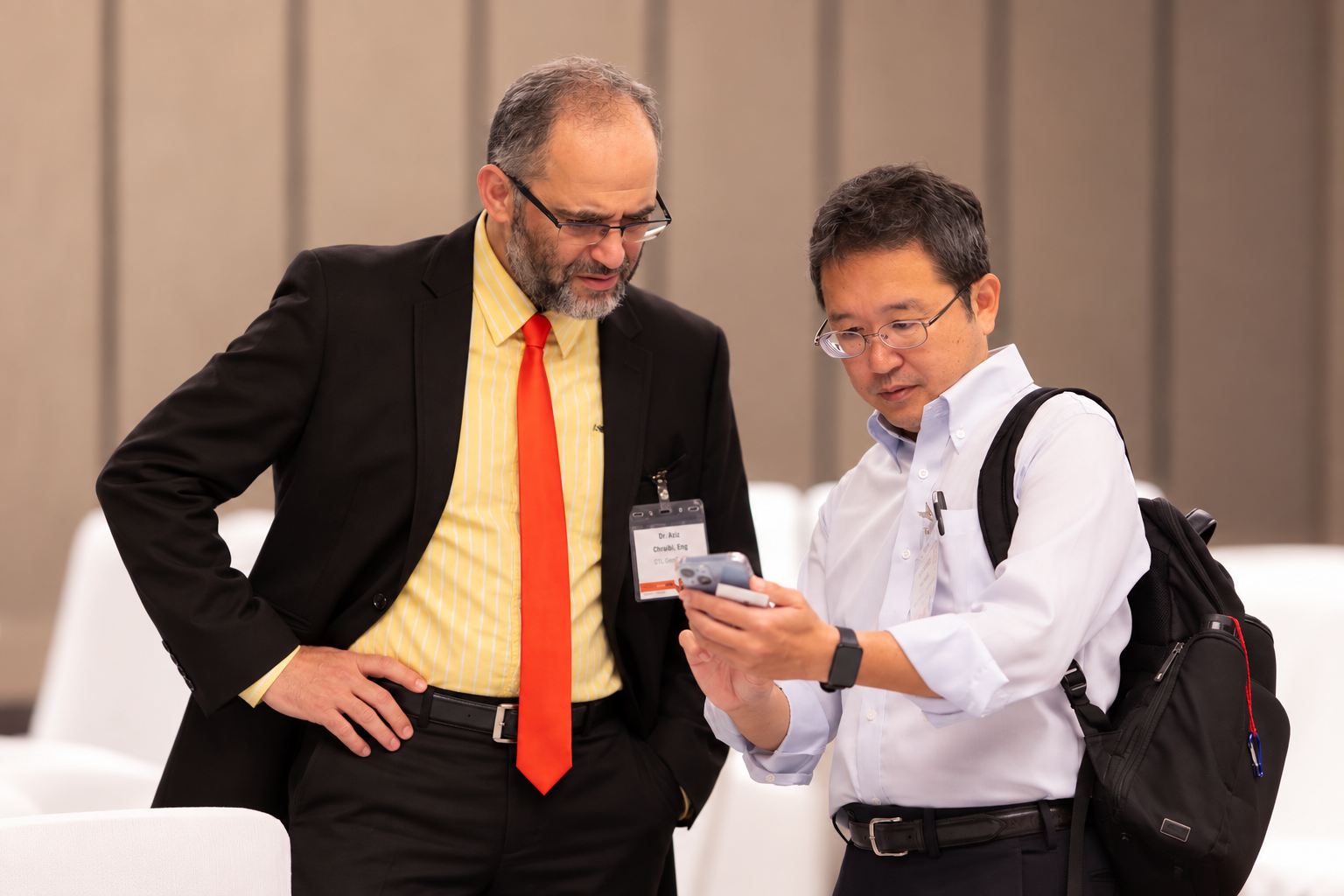 A PBE Expert engineer talks with a client at a professional event.