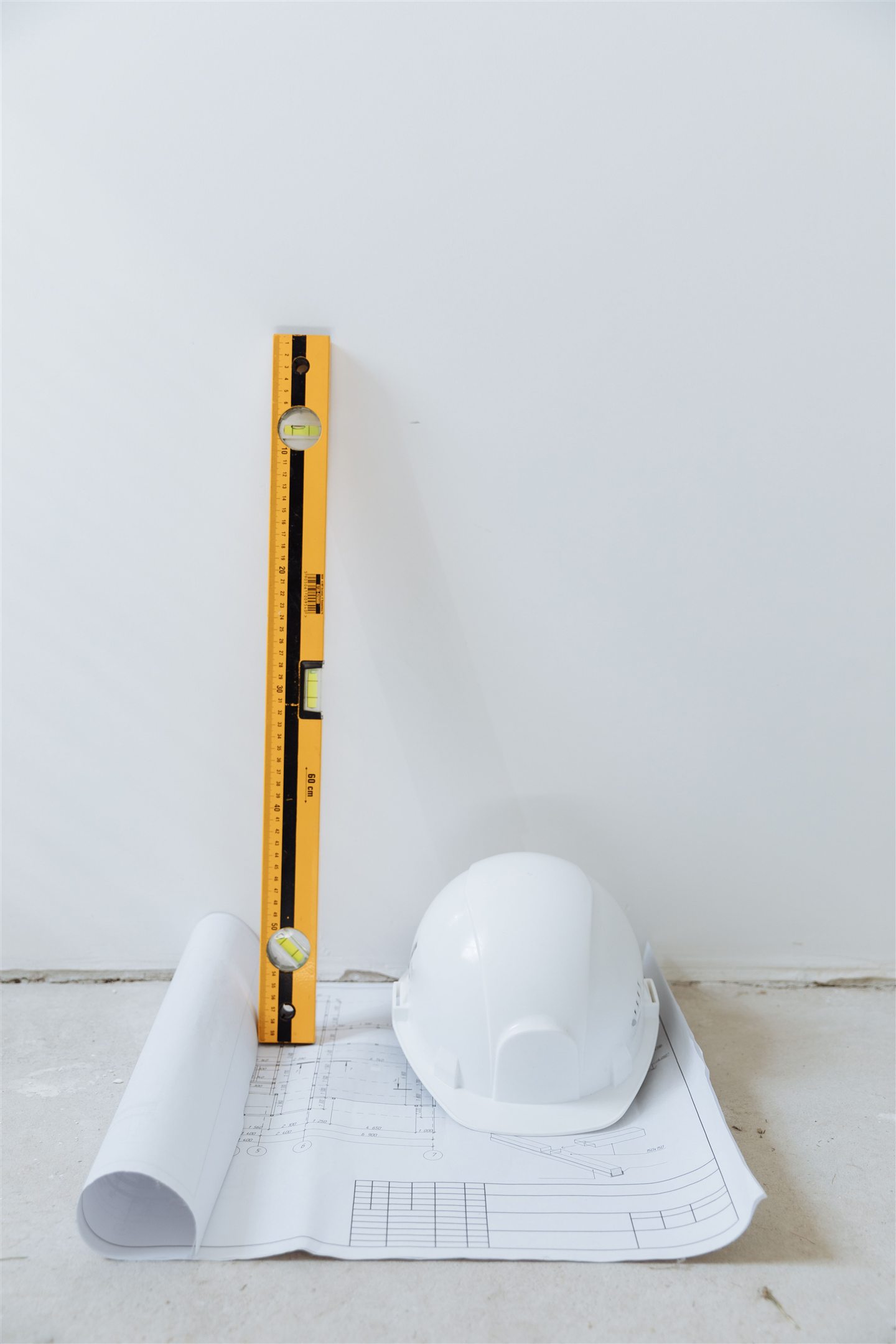Level leaning against a freshly prepared wall