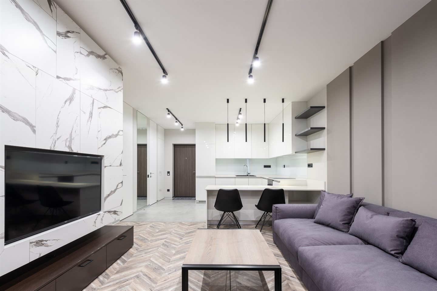 Salon moderne au mur de marbre blanc ouvert sur la cuisine