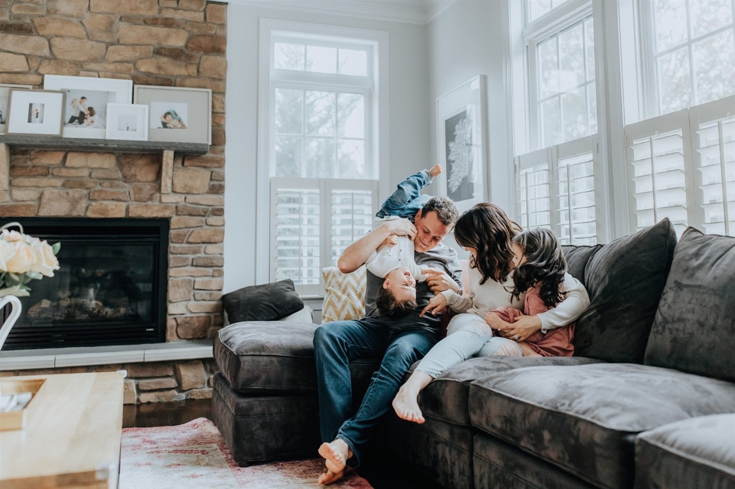 Family together on a sofa in a bright living room
