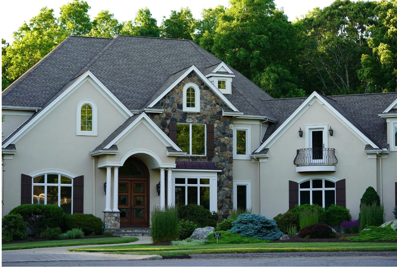 Stone house surrounded by trees and greenery